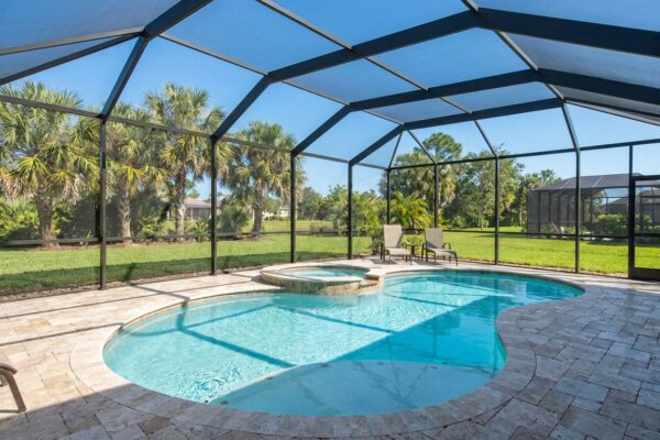 Custom kidney-shaped pool with screen enclosure in Florida