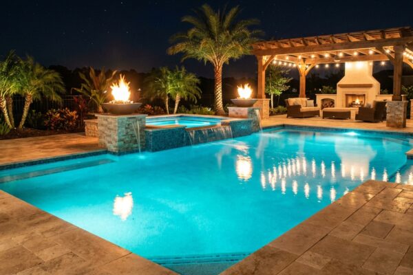 Luxury pool with fire bowls and LED lighting at night